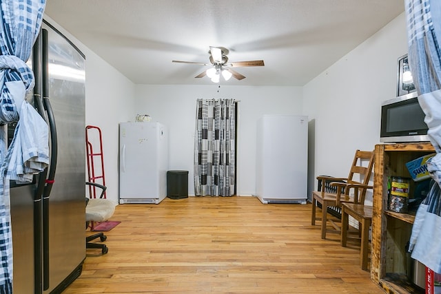 office space featuring ceiling fan, a textured ceiling, and light wood-type flooring