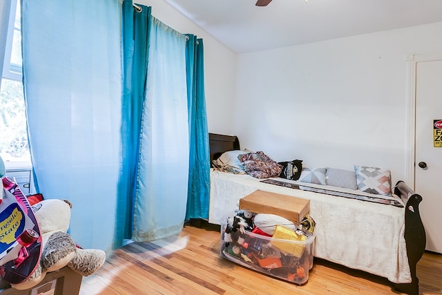 bedroom with wood-type flooring and ceiling fan