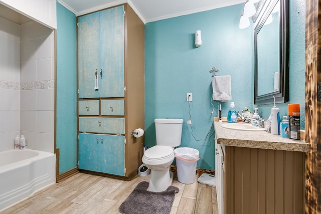 full bathroom featuring crown molding,  shower combination, vanity, wood-type flooring, and toilet