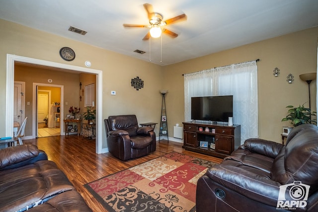 living room with hardwood / wood-style floors and ceiling fan