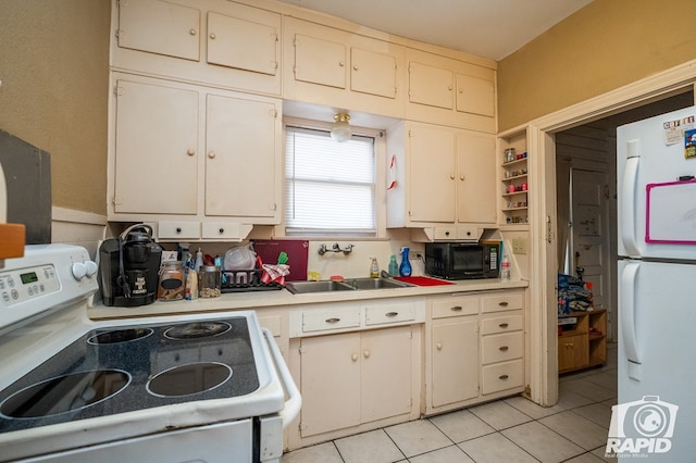 kitchen with light tile patterned flooring, white appliances, white cabinetry, and sink