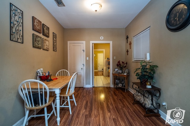 dining area with dark hardwood / wood-style flooring