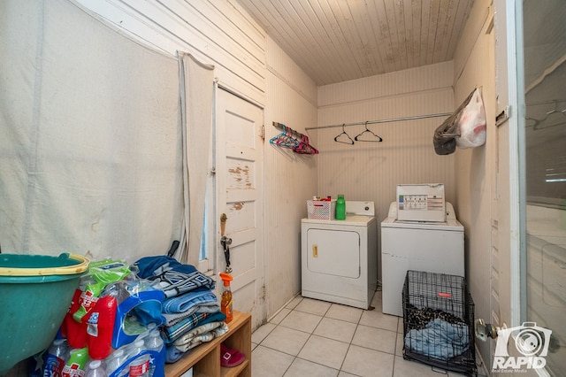 washroom featuring washing machine and clothes dryer and light tile patterned floors