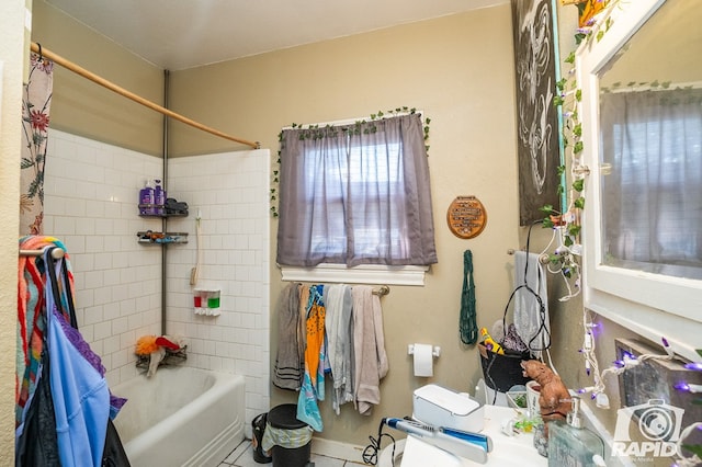 bathroom with tile patterned floors and tiled shower / bath combo