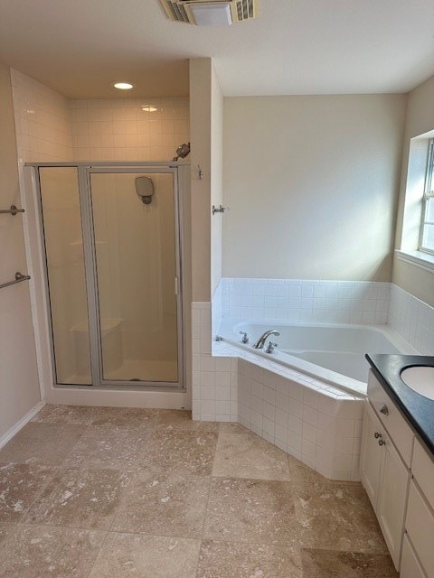 bathroom with vanity and plus walk in shower