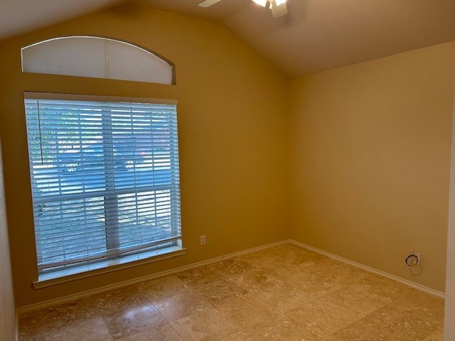 unfurnished room featuring lofted ceiling and ceiling fan