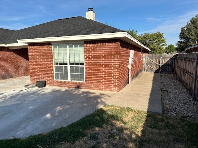 view of side of home with a patio