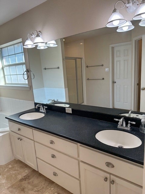 bathroom with vanity and separate shower and tub