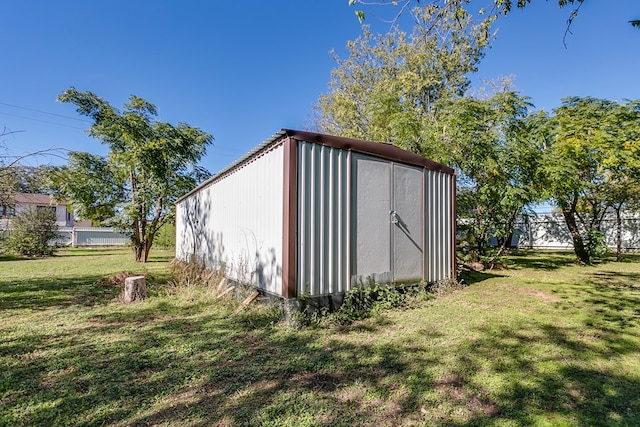 view of outbuilding featuring a lawn