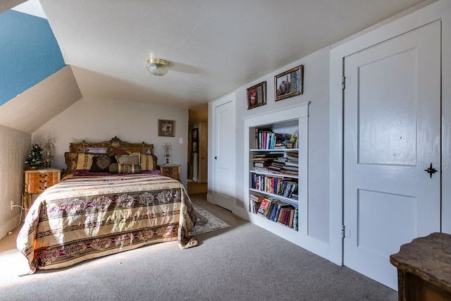 carpeted bedroom featuring ceiling fan, vaulted ceiling, and a textured ceiling