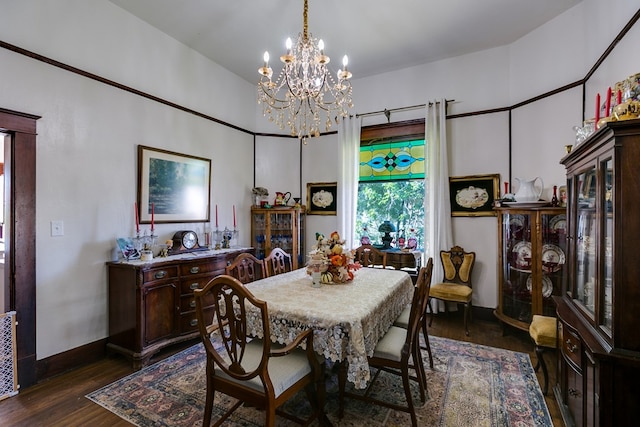 dining room with a notable chandelier and dark hardwood / wood-style floors