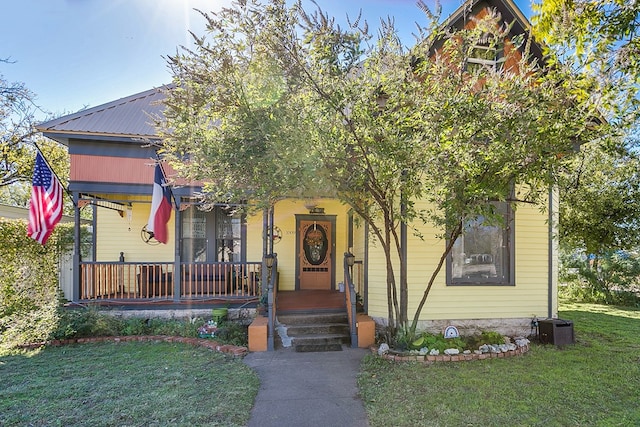 view of front of property with covered porch and a front yard