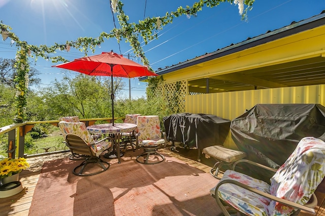 view of patio with a wooden deck and a grill