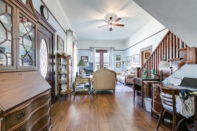 living room featuring ceiling fan and dark hardwood / wood-style flooring