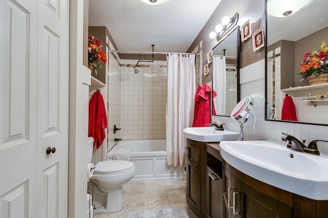 full bathroom featuring shower / bath combo, vanity, and toilet