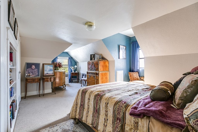 carpeted bedroom featuring vaulted ceiling and a textured ceiling