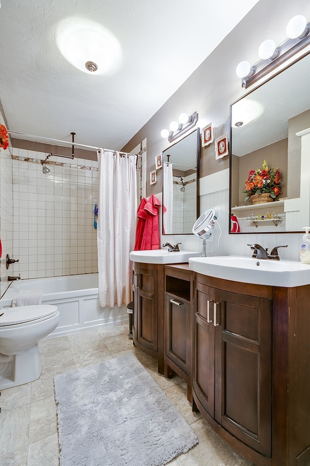 full bathroom with vanity, toilet, a textured ceiling, and shower / bath combo