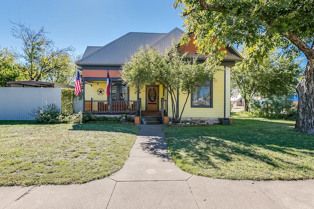 view of front of house with a porch and a front lawn