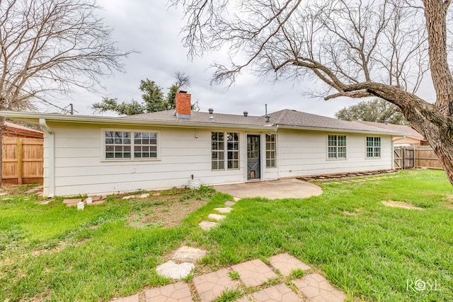 3102 Chatterton Dr, San Angelo, TX 76904 - back of house with a chimney, fence, a lawn, and a patio area