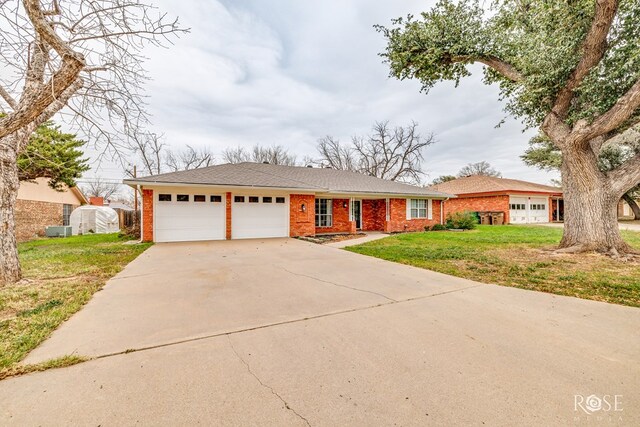 3102 Chatterton Dr, San Angelo, TX 76904 - ranch-style house with concrete driveway, a front yard, brick siding, and a garage