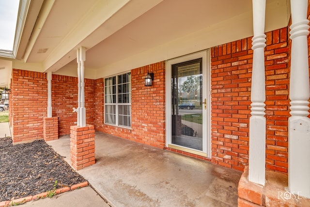 3102 Chatterton Dr, San Angelo, TX 76904 - doorway to property featuring a porch and brick siding