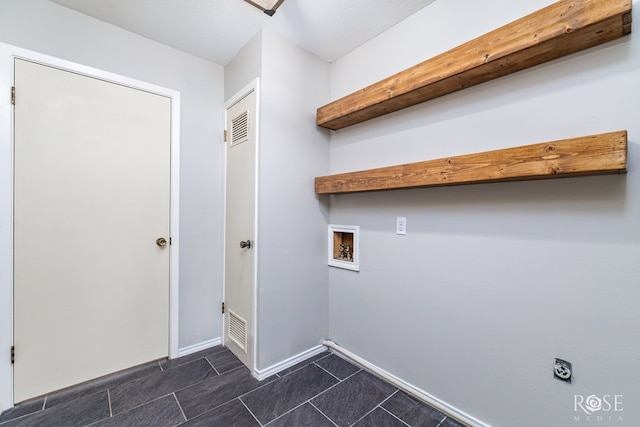 3102 Chatterton Dr, San Angelo, TX 76904 - laundry area with electric dryer hookup, baseboards, hookup for a washing machine, dark tile patterned flooring, and laundry area