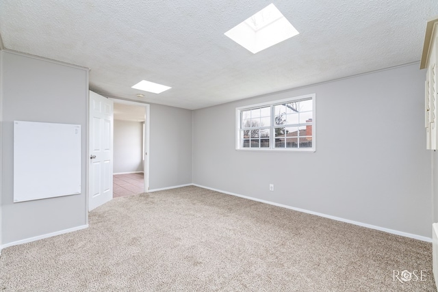 3102 Chatterton Dr, San Angelo, TX 76904 - carpeted empty room featuring baseboards, a skylight, and a textured ceiling