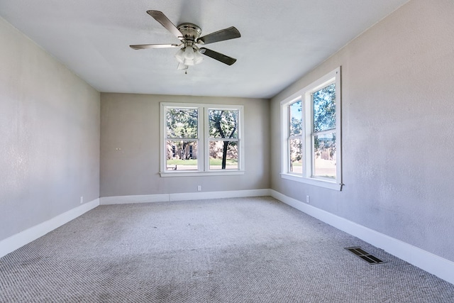 carpeted empty room featuring ceiling fan