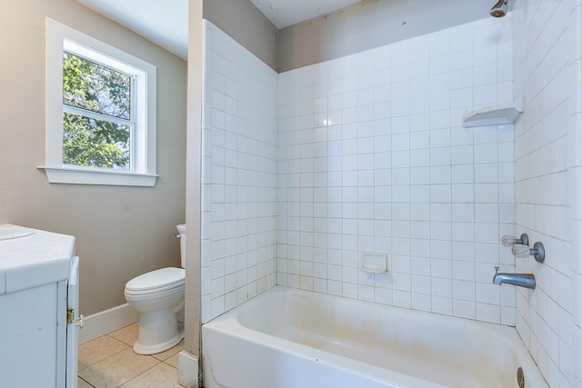 full bathroom featuring tile patterned flooring, vanity, tiled shower / bath combo, and toilet