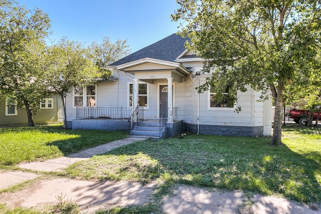 bungalow-style house with a front lawn