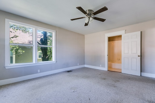 empty room featuring ceiling fan and carpet flooring