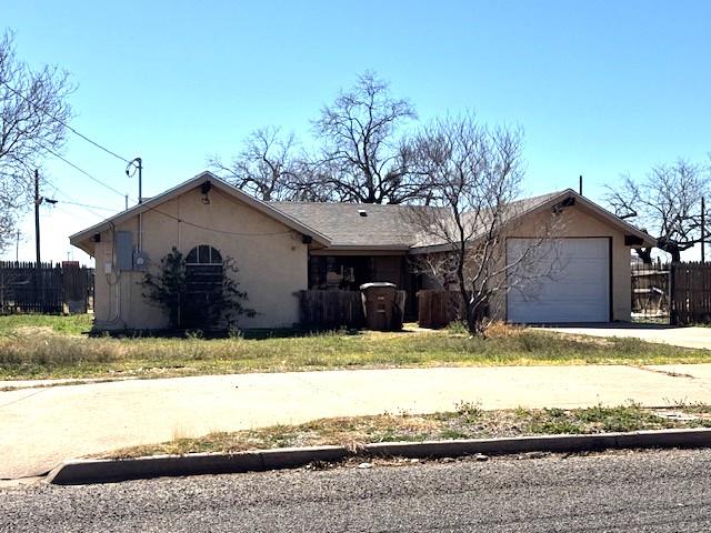 445 8th St, San Angelo, TX 76901 - view of front of property featuring concrete driveway, fence, an attached garage, and stucco siding