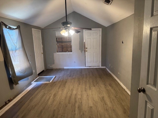 445 8th St, San Angelo, TX 76901 - unfurnished living room featuring wood finished floors, vaulted ceiling, ceiling fan, and baseboards
