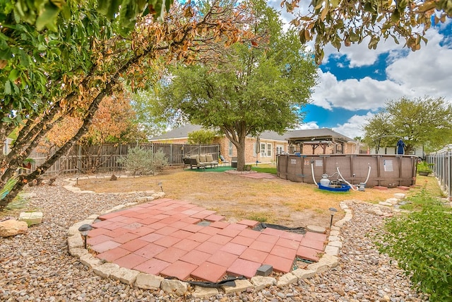 1001 Avondale Ave, San Angelo, TX 76901 - fenced backyard with a patio area