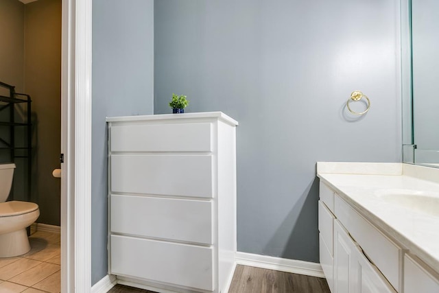 1001 Avondale Ave, San Angelo, TX 76901 - bathroom featuring toilet, vanity, and baseboards