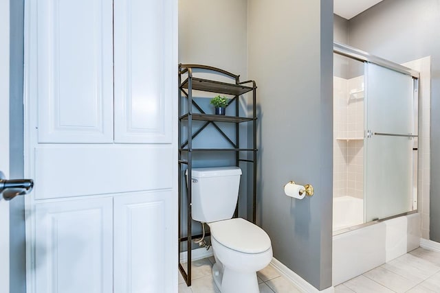 1001 Avondale Ave, San Angelo, TX 76901 - full bathroom with toilet, enclosed tub / shower combo, baseboards, and tile patterned floors