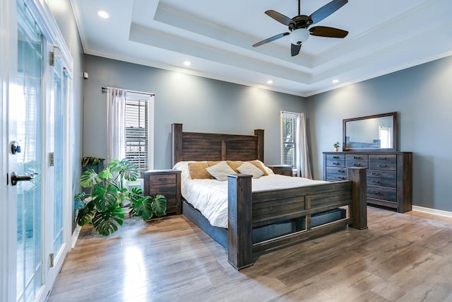 1001 Avondale Ave, San Angelo, TX 76901 - bedroom with multiple windows, crown molding, light wood-type flooring, a tray ceiling, and recessed lighting