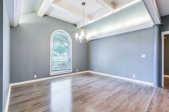 1001 Avondale Ave, San Angelo, TX 76901 - spare room featuring wood finished floors, a chandelier, ornate columns, and baseboards