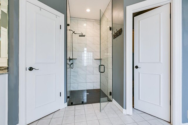 1001 Avondale Ave, San Angelo, TX 76901 - bathroom with a stall shower, baseboards, tile patterned flooring, and recessed lighting