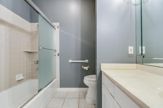 1001 Avondale Ave, San Angelo, TX 76901 - full bath featuring vanity, toilet, combined bath / shower with glass door, baseboards, and tile patterned flooring