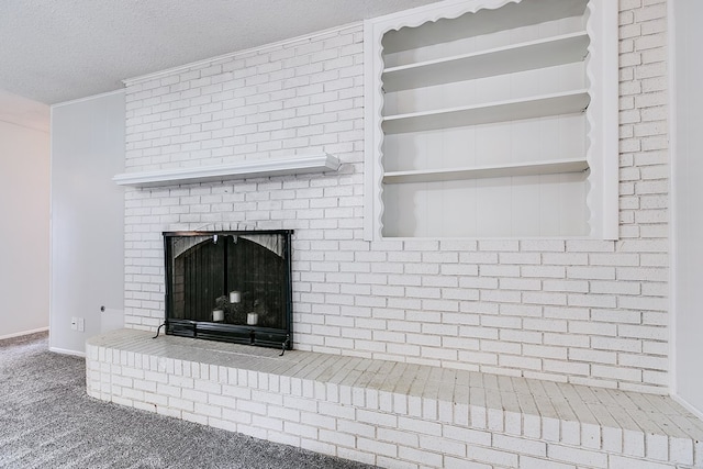 interior details with a textured ceiling, a brick fireplace, and carpet flooring