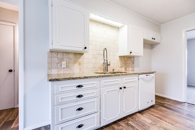 kitchen with white dishwasher, light hardwood / wood-style flooring, light stone countertops, white cabinets, and sink