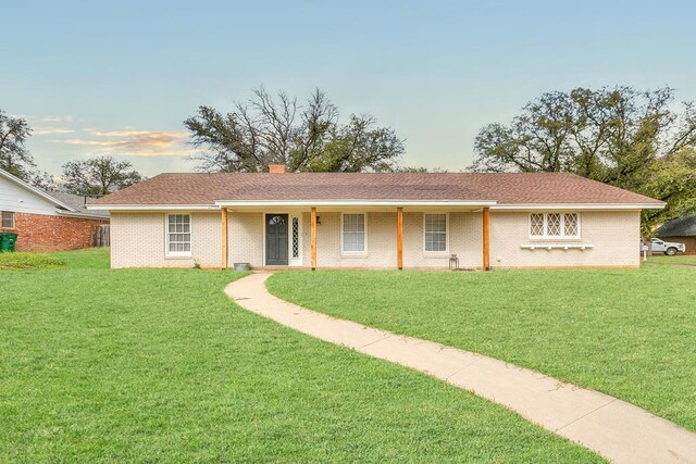 ranch-style house with a yard