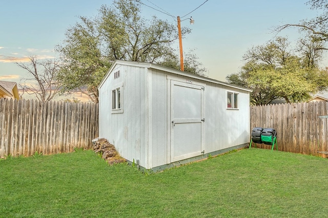 outdoor structure at dusk featuring a yard