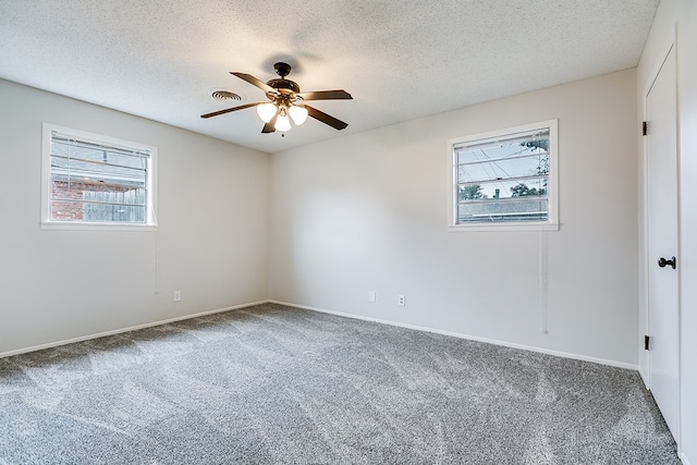 spare room with ceiling fan, carpet flooring, and a textured ceiling