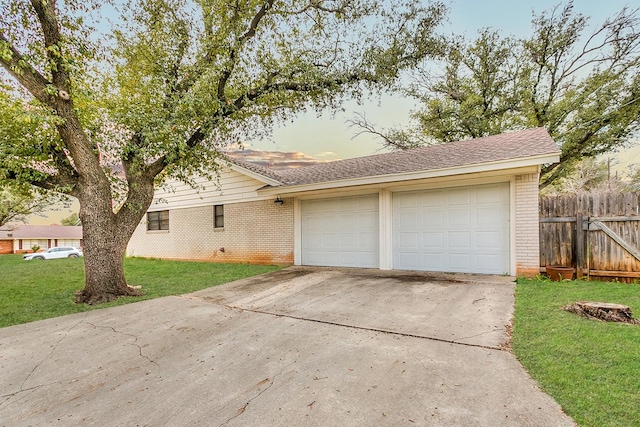 view of front of property featuring a garage and a lawn