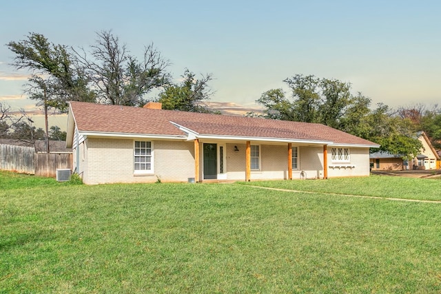 ranch-style home with a yard and cooling unit