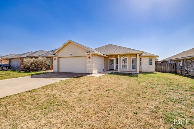 ranch-style house featuring driveway, brick siding, an attached garage, and a front yard