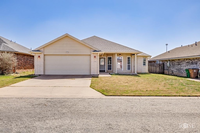 single story home featuring a garage, brick siding, driveway, and a front lawn