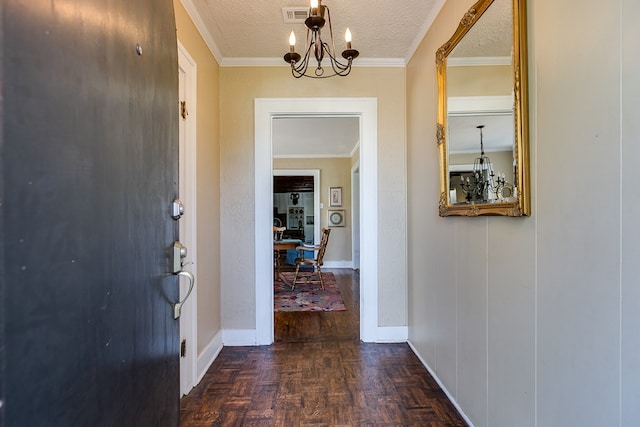 hall featuring crown molding, an inviting chandelier, a textured ceiling, and dark parquet floors